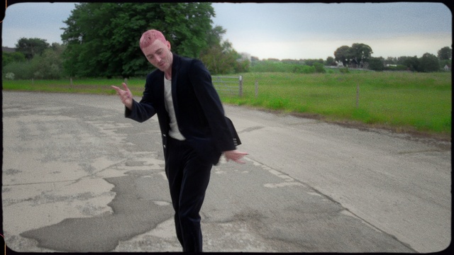 Video Reference: Plant, Tree, Road surface, Sky, Sleeve, Asphalt, Dress shirt, Gesture, Flash photography, Grass