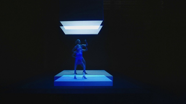 Video Reference: Performing arts, Entertainment, Electric blue, Event, Performance art, Display device, Fictional character, Symmetry, Art, Darkness