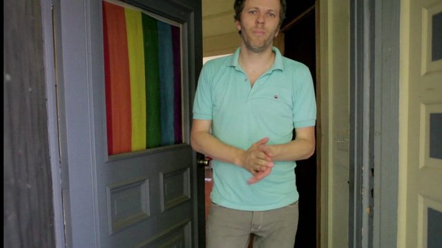 Video Reference: man, doorway, indoor, standing, polo shirt, rainbow, door, hallway, home, portrait, casual clothing