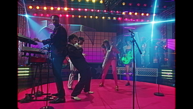 Video Reference: Public address system, Musical instrument, Purple, Musician, Microphone, Music artist, Artist, Performing arts, Entertainment, Concert