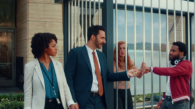 Video Reference: Outerwear, Daytime, Tie, Coat, Gesture, Suit, Blazer, White-collar worker, Formal wear, Event