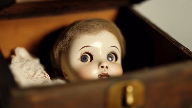 Video Reference: porcelain doll, vintage, toy, close-up, wooden box, antique, blue eyes, creepy, face, still life, indoors, macabre, retro