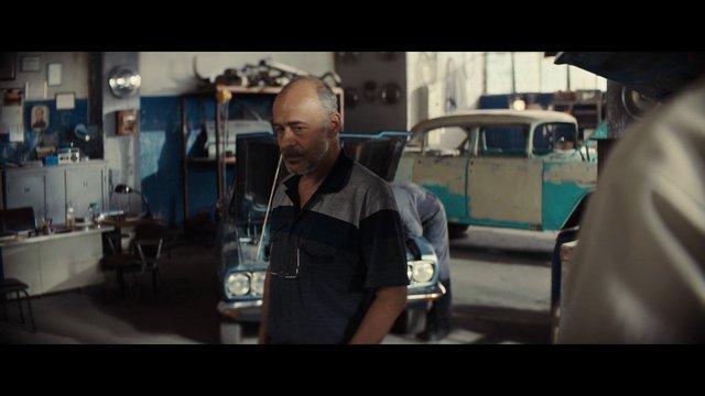 Video Reference: garage, auto repair, mechanic, man, vintage car, workshop, indoor, car interior, classic vehicle, industry, vehicle