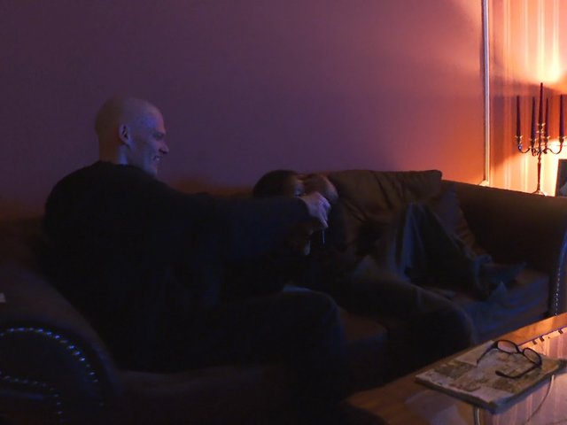 Video Reference: living room, couch, indoor, dim light, lamp, two people, conversation, home, evening, interior, shadowy, relaxing