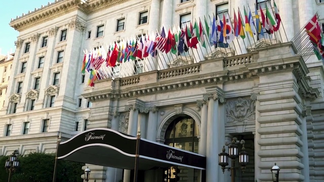 Video Reference: Daytime, Window, Building, Neighbourhood, Flag, Public space, City, Real estate, Metropolis, Facade