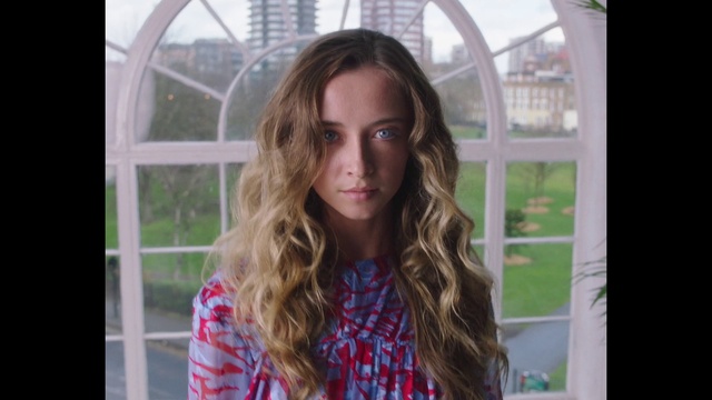 Video Reference: Hair, Lip, Hairstyle, Shoulder, Facial expression, Neck, Iris, Tartan, Eyelash, Happy