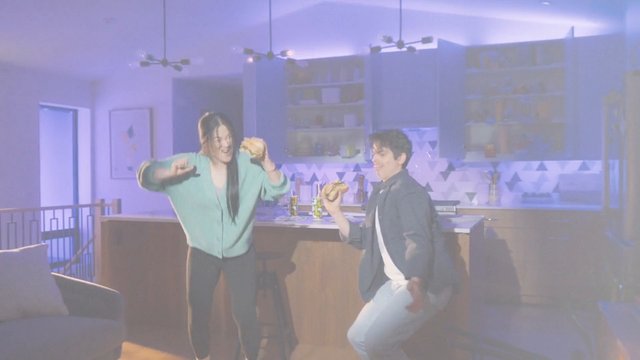 Video Reference: people, dancing, kitchen, sandwiches, indoors, modern home, party, fun, friends, casual, interior, lifestyle, food, evening, colorful lighting