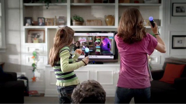 Video Reference: children, living room, video game, gaming, television, motion controller, indoor, family, play, entertainment, home, back view