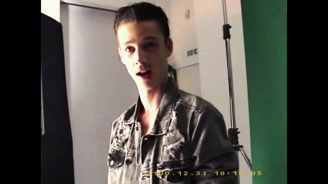 Video Reference: Sleeve, Flash photography, Gesture, T-shirt, Street fashion, Event, Fashion design, Audio equipment, Eyewear, Font