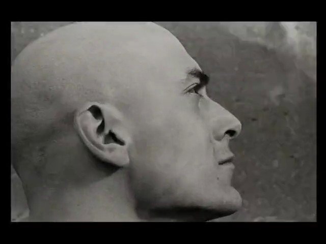 Video Reference: black and white, portrait, profile, close-up, bald man, male, face, side view, studio-like, minimal background