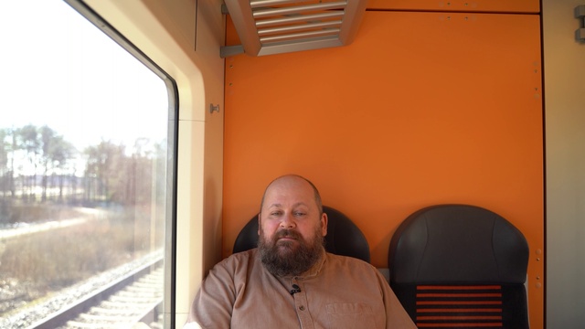 Video Reference: Beard, Wood, Train, Comfort, Facial hair, Track, Railway, Rolling stock, Public transport, Room