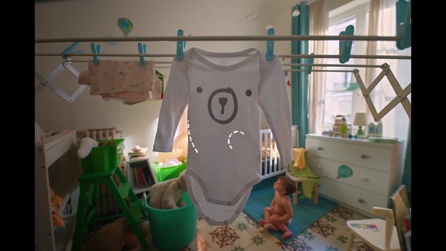 Video Reference: Blue, Green, Sleeve, T-shirt, Fashion design, Drawer, Font, Event, Chest of drawers, Room