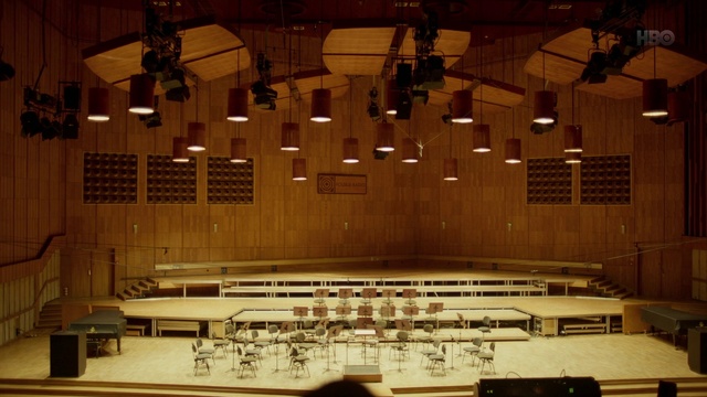 Video Reference: Wood, Flooring, Art, Musical instrument accessory, Hardwood, Font, Event, Symmetry, Entertainment, Chair