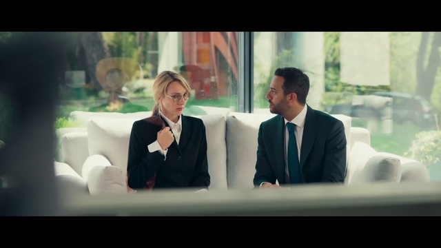 Video Reference: Coat, Gesture, Suit, Television program, Blazer, Formal wear, White-collar worker, Event, Display device, Fun