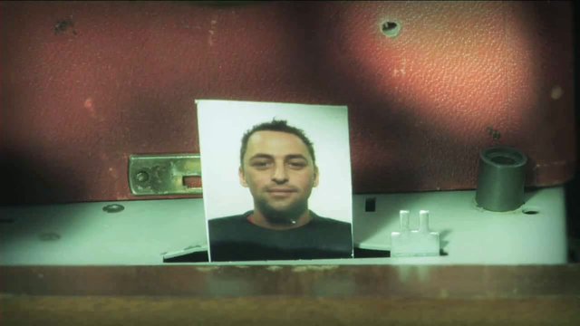Video Reference: portrait, printed photo, man, paper, indoors, close-up, still life, prop, background, hardware, surface, mugshot, documentary, textless, single subject