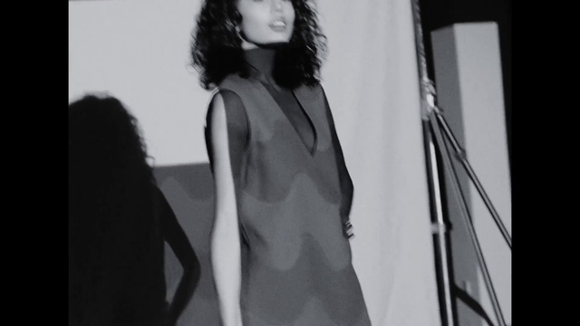 Video Reference: Hairstyle, Flash photography, Sleeve, Waist, Dress, Gesture, Black-and-white, Style, Fashion design, Black hair