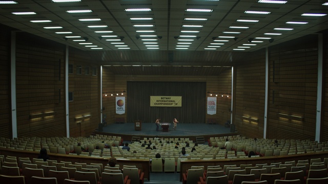 Video Reference: Furniture, Hall, Chair, Lighting, Interior design, Building, Event, Ceiling, Stage, Room