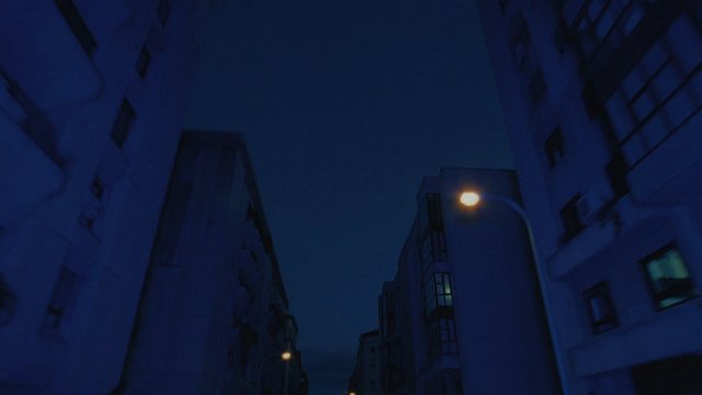 Video Reference: night, city, urban, buildings, apartments, streetlight, sky, architecture, low_angle, blue_tone, evening, residential, exterior, street, vertical