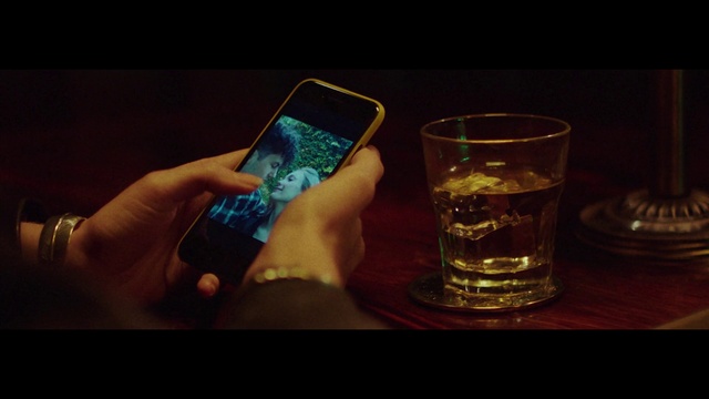 Video Reference: Hand, Drinkware, Communication Device, Gesture, Finger, Mobile phone, Barware, Alcoholic beverage, Liquid, Mobile device