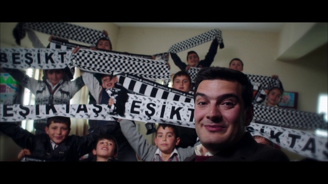 Video Reference: Forehead, Gesture, Smile, Crowd, T-shirt, Event, Hat, Fan, Font, Happy