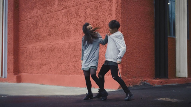 Video Reference: Footwear, Shorts, Orange, Flash photography, Gesture, Street fashion, Performing arts, Jacket, Entertainment, Suit