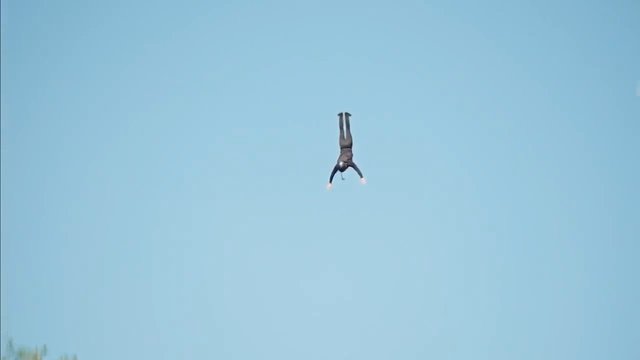 Video Reference: person, sky, upside down, midair, jump, falling, silhouette, outdoors, blue sky, action, distant, copy space