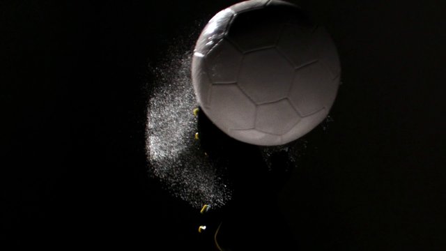 Video Reference: soccer, football, ball, sports, action, impact, motion, powder, droplets, close-up, dark background, studio, dynamic, macro, game, energy