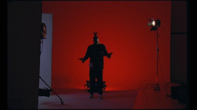 Video Reference: Unicycle, Building, Sculpture, Art, Performing arts, Entertainment, Event, Sky, Audio equipment, Magenta