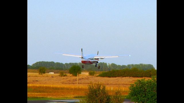 Video Reference: airplane, small plane, aviation, landing, takeoff, flying, rural, airfield, sky, fields, trees, outdoors