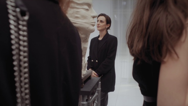 Video Reference: Neck, Sleeve, Standing, Gesture, Street fashion, Style, Fashion design, Blazer, Formal wear, Event