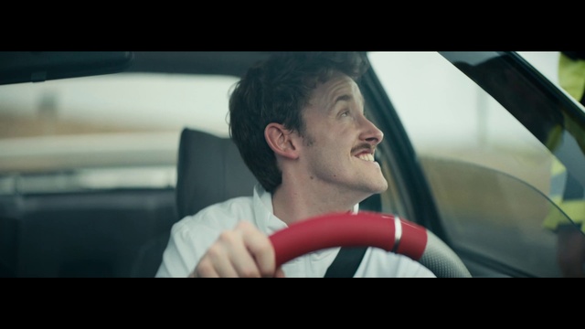 Video Reference: Vehicle, Car, Smile, Automotive mirror, Motor vehicle, Flash photography, Automotive design, Steering wheel, Steering part, Gesture