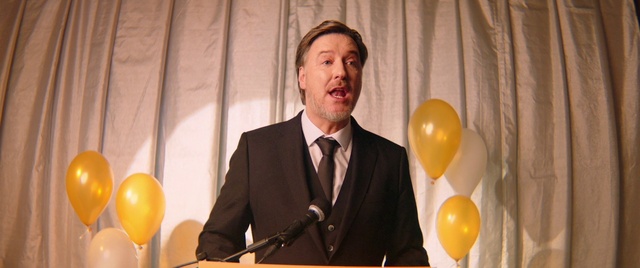 Video Reference: Microphone, Tie, Organ, Balloon, Dress shirt, Yellow, Public address system, Podium, Suit, Blazer