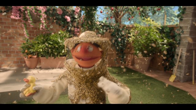Video Reference: garden, patio, puppet, straw hat, bees, duck toy, potted plants, flowers, brick wall, outdoor, whimsical, animation, character, insects, backyard, motion blur