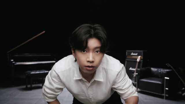 Video Reference: Eyebrow, Flash photography, Jaw, Sleeve, Dress shirt, Collar, Black hair, Elbow, T-shirt, Chair