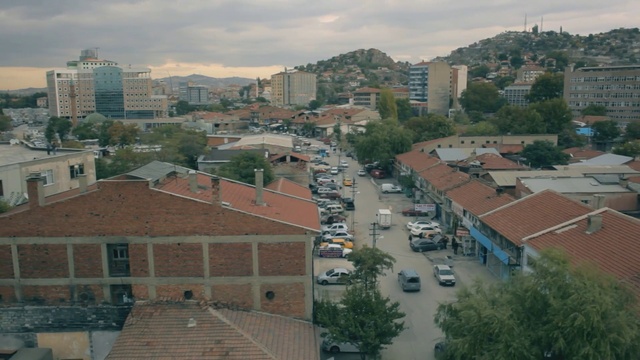 Video Reference: Sky, Cloud, Daytime, Car, Building, Plant, Window, Infrastructure, Tree, Urban design