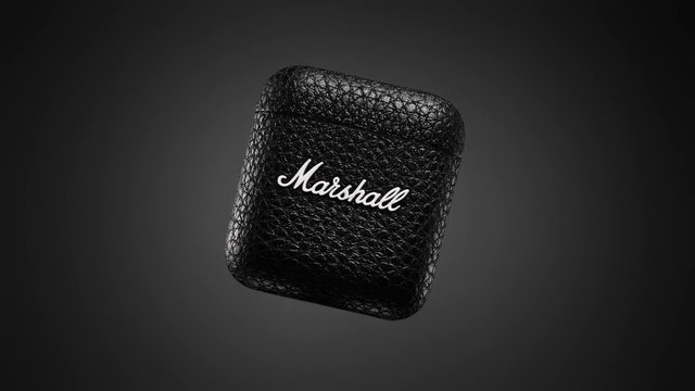 Video Reference: earbud case, charging case, wireless earbuds, black, textured surface, product shot, isolated object, dark background, brand logo, audio accessory, electronics, minimalist