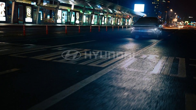 Video Reference: Automotive lighting, Road surface, Asphalt, Mode of transport, Electricity, Line, Headlamp, City, Vehicle, Metropolitan area