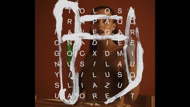 Video Reference: woman, portrait, glass, letters, text overlay, abstract, paint strokes, brown background, artistic, studio, face, close-up, fashion, modern, creative, graphic