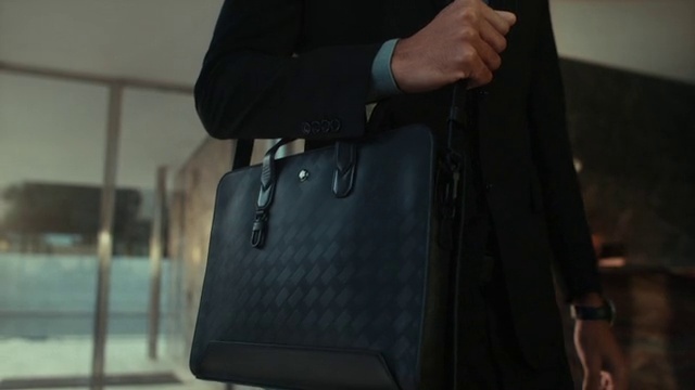 Video Reference: Luggage and bags, Sleeve, Bag, Gesture, Grey, Collar, Waist, Travel, Business bag, Blazer