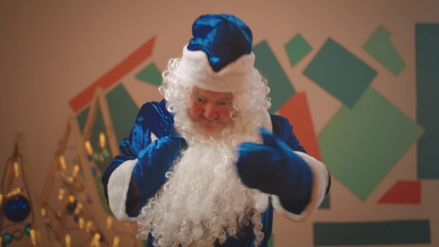 Video Reference: Head, Beard, Hat, Santa claus, Blue, Human body, Textile, Facial hair, Toy, Happy