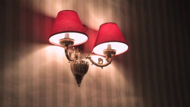 Video Reference: wall lamp, sconce, double light, red lampshade, interior, lighting, decor, fixture, warm light, wall decor, room, ornamental, classic, ambient, home, indoor