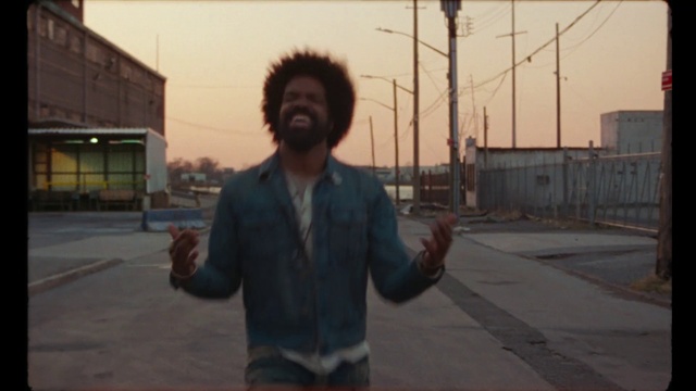 Video Reference: Head, Sky, Flash photography, Asphalt, Road surface, Gesture, Sunlight, Eyewear, Beard, Street fashion