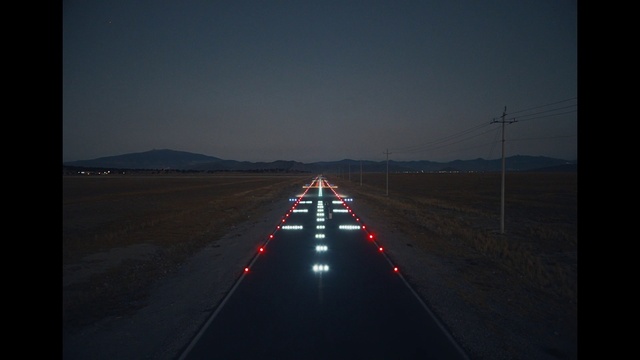 Video Reference: Sky, Automotive lighting, Road surface, Asphalt, Runway, Horizon, Landscape, Electricity, Astronomical object, Midnight