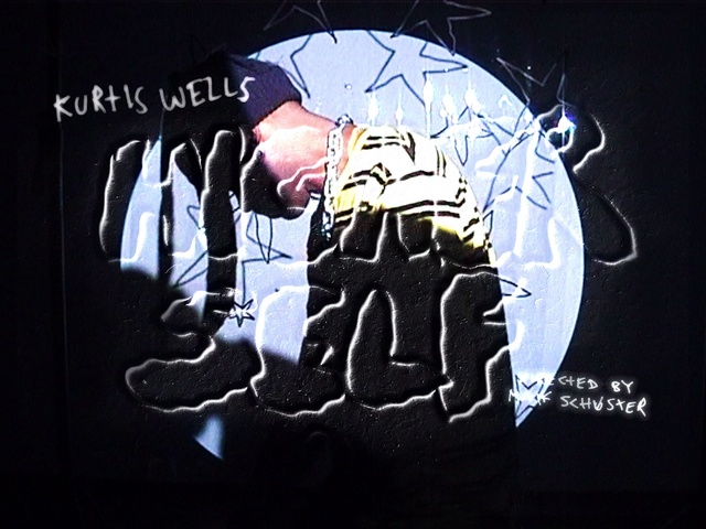 Video Reference: Sleeve, Gesture, Font, Art, T-shirt, Darkness, Fictional character, Graphics, Electric blue, Event