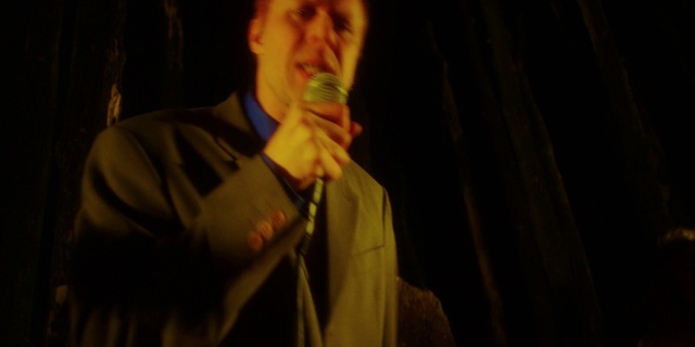 Video Reference: Microphone, Dress shirt, Sleeve, Gesture, Entertainment, Musician, Music, Audio equipment, Performing arts, Event