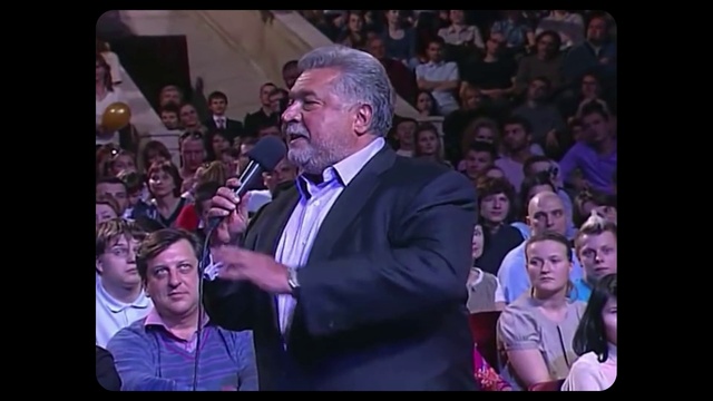 Video Reference: Clothing, Face, Head, Microphone, Purple, Tie, Entertainment, Music artist, Interaction, Public address system