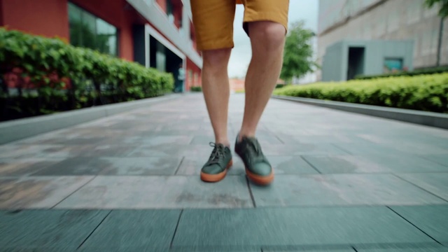 Video Reference: Footwear, Plant, Green, Window, Street fashion, Road surface, Thigh, Knee, Flooring, Asphalt