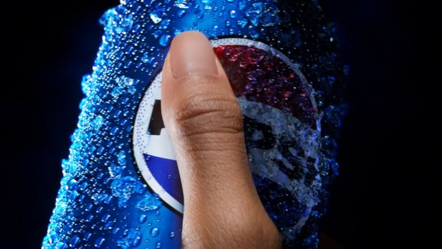 Video Reference: close-up, hand, finger, beverage can, soda, blue can, water droplets, condensation, macro, drink, product shot, dark background