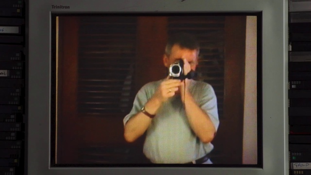 Video Reference: Mirror, Vision care, Sleeve, Photographer, Gesture, Cameras & optics, Rectangle, Picture frame, T-shirt, Gadget