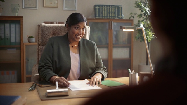 Video Reference: Smile, Table, Plant, Picture frame, Houseplant, Desk, Writing desk, Window, Chair, White-collar worker